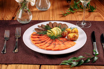 Smoked salmon platter appetizer with bread and potato