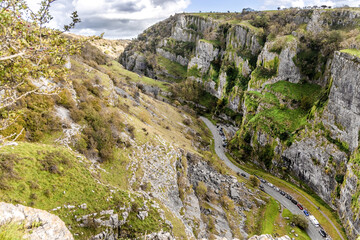 View from cliffs edge of winding road cars Cheddar Gorge in Somerset