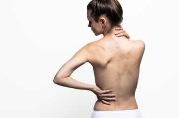 Back view of a woman with great skin. Pain, skin care. Isolated on white background.