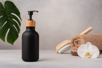 Elegant black soap dispenser with bamboo cap in spa setting