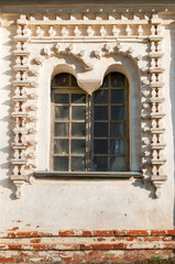 Veliky Novgorod, Russia. Old medieval window decorated with stucco in Resurrection Cathedral of Derevyanitsky monastery in Veliky Novgorod surroundings