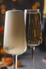 Champagne is poured into a glass from a bottle