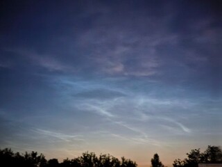 The sky on the background of sunset, colorful clouds. An abstract composition in nature with natural purple and pink shades of the horizon. The natural environment.