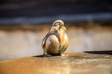 Miniature statue of metal bronze color bird