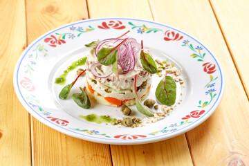 russian salad on the wooden background