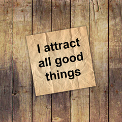 I attract all good things - positive affirmation words - handwriting on a white paper