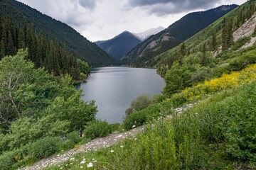 Kolsai high-altitude lake in the Tien Shan mountain system, Kazakhstan. A summer day. Travel, tourism, vacation, outdoor recreation.