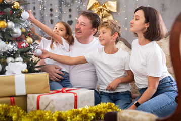 Portrait of family who is satisfied of gifts in time celebration New Year at home