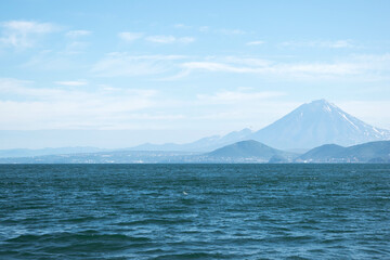 Avacha Bay of the Pacific Ocean, the coast of the Russian Far East, the Kamchatka Peninsula, a view of the city of Petropavlovsk-Kamchatsky and volcanoes from the water