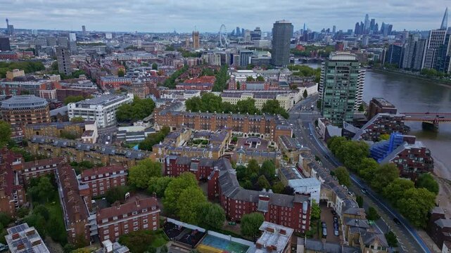 Pimlico neighborhood and riverside with Millbank Tower and Big Ben in background, London cityscape. Aerial drone forward
