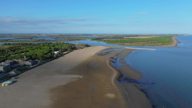 large swaths of beach used for a power station, commercial fishing activities, and local pleasure boating just north of Venice, Italy