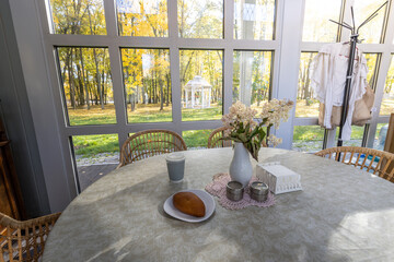 A table with a vase of flowers and a plate of food