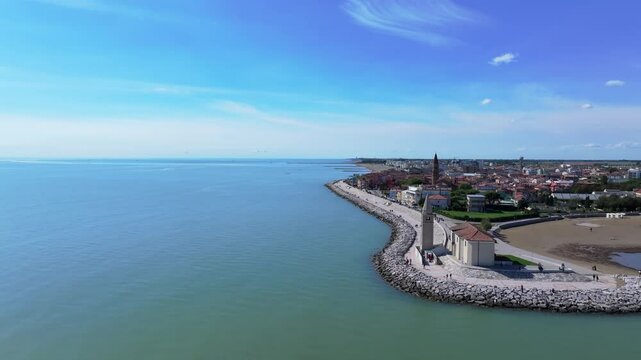 speedy aerial flying down the coastal town of Caorle on the Adriatic Sea, Italy near the Chapel of Madonna dell'Angelo