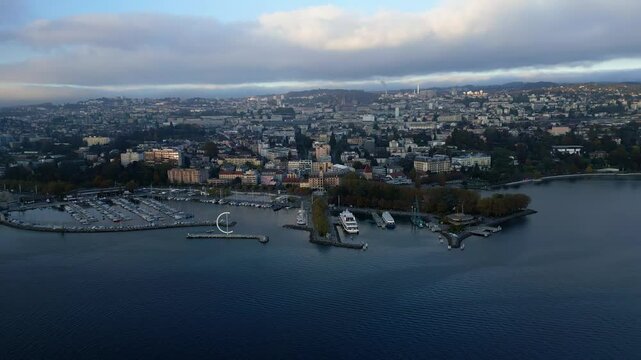 Pan drone shot of Eole Sculpture and Ouchy Port at sunset in Lausanne Switzerland