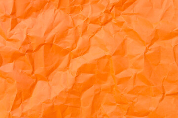 Top view and full frame of wrinkled or crumpled orange paper used as crumpled orange paper...