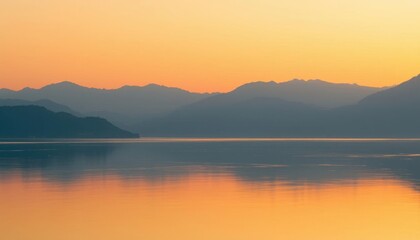 Obraz premium mountains are in the distance behind a body of water