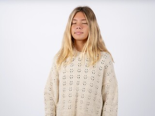 Obraz premium caucasian teen girl wearing knitted sweater over white nice-looking sweet charming cute attractive lovely winsome sweet peaceful closed eyes