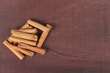 Cinnamon sticks on a wooden background