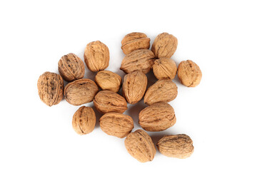 Several whole walnuts on a white background