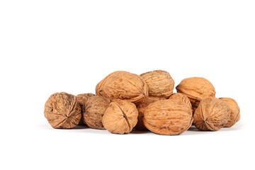 Several whole walnuts on a white background