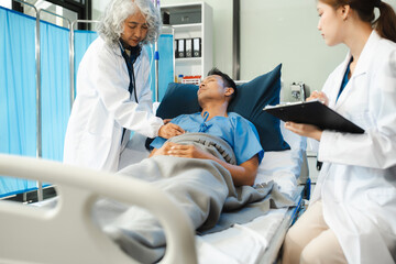 doctor talking to male patient at bed in hospital.