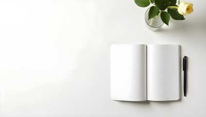 Open notebook mockup with blank pages, pen, and a rose in a vase for creative designs