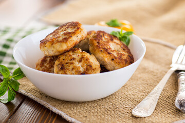 fried chicken cutlets in a bowl on a wooden table
