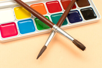 Paintbrush and palette of watercolor paints	