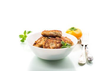fried chicken cutlets in a bowl, isolated on white background
