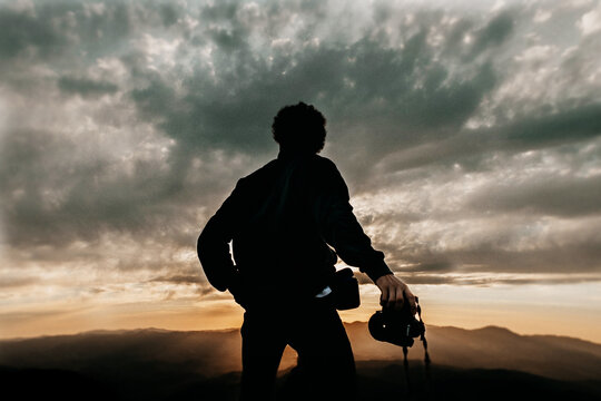 sky landscape, silhouette texture of boy photographer with camera for photo and videoclouds