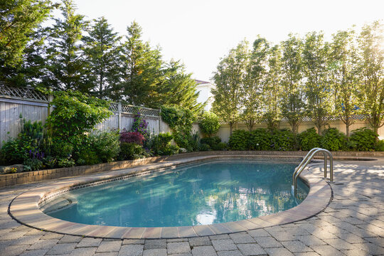 USA, New York, Long Beach, Swimming pool and trees in backyard