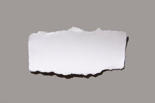Torn peace of paper on gray background