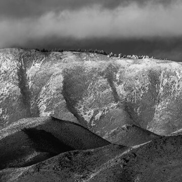 Low clouds covering foothills in snow, black and white
