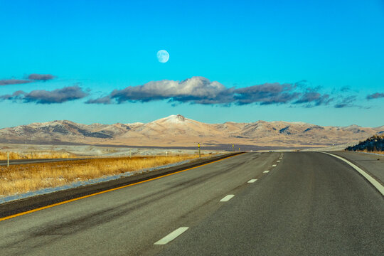 Moon and clouds over empty Interstate 80