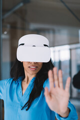 Woman in VR goggles looking at camera
