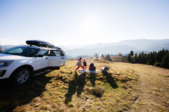 Family enjoying outdoor picnic with scenic mountain view