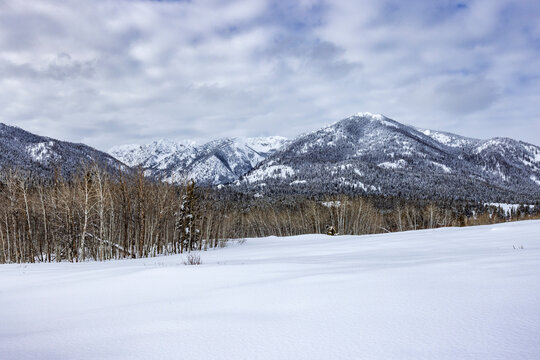 Tranquil winter landscape with snow covered field and hills