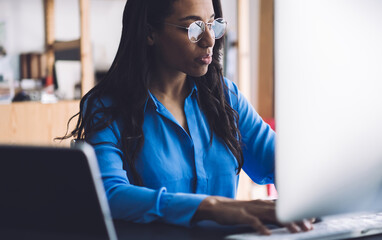 Serious woman typing on keyboard