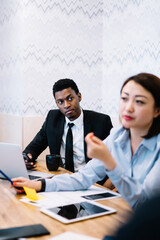 Diverse office colleagues sitting at workplace