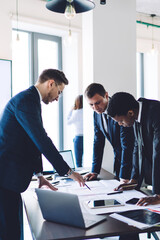 Multiracial group of colleagues working on business project