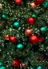 Vertical background of red, green, orange balls toys and lights green indoor Christmas tree New Year