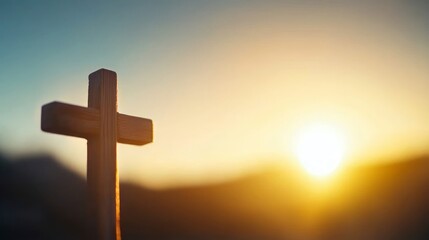 A wooden cross silhouetted against a vibrant sunset, symbolizing faith and hope.