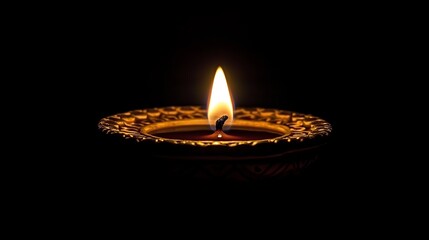 A lit oil lamp glowing in darkness, symbolizing hope and light.