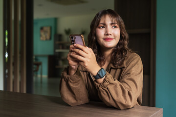 Portrait of Beautiful And Young Cute Asian Woman Sitting Indoors