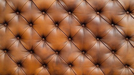 Close-up of tufted brown leather upholstery with button detailing, showcasing a pattern typical of classic furniture design.