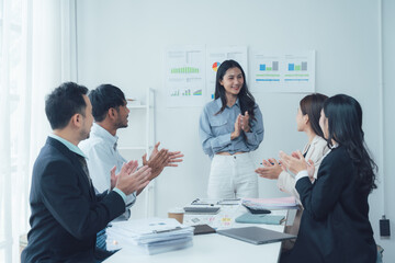 Business Meeting Applause: A diverse group of professionals in a modern office setting show their appreciation for a colleague's presentation, creating a scene of positive energy and collaboration.  