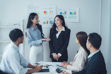 Collaborative Business Meeting: A diverse team engages in a productive meeting, discussing strategies and ideas around a table in a modern office setting.