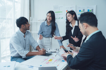 Dynamic Business Meeting: A diverse team of professionals engages in a lively discussion, showcasing the collaborative spirit and strategic thinking that fuels their success.  