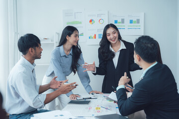Business Meeting: A collaborative and engaging meeting between a diverse team of professionals, showcasing their dedication and teamwork in a modern office setting.  