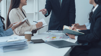 Collaborative Brainstorming: A diverse team of professionals engages in a productive meeting, ideas flowing and notes being taken.